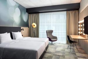 a hotel room with a bed and a desk at STAGES HOTEL Prague, a Tribute Portfolio Hotel in Prague