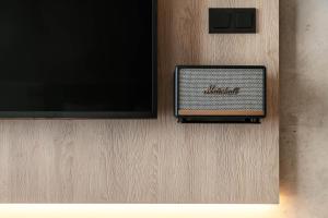 a television on a wall with a box on it at STAGES HOTEL Prague, a Tribute Portfolio Hotel in Prague