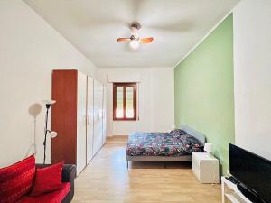 1 dormitorio con 1 cama y ventilador de techo en Be Your Home - Casa Vacanze Il Posticino, en Civitavecchia