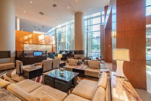 a lobby with couches and tables in a building at The Woodlands Waterway Marriott Hotel and Convention Center in The Woodlands