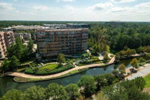 an aerial view of a building next to a river at The Woodlands Waterway Marriott Hotel and Convention Center in The Woodlands