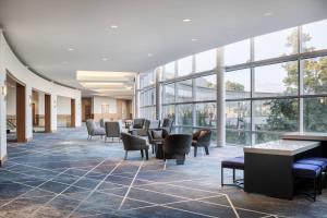 a lobby with chairs and tables and windows at The Woodlands Waterway Marriott Hotel and Convention Center in The Woodlands +86 photos