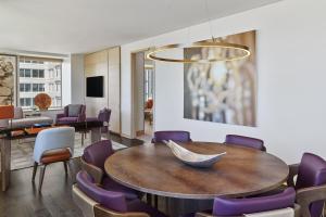 a dining room with a table and purple chairs at The St Regis San Francisco in San Francisco
