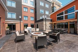 eine Terrasse mit Stühlen und einer Feuerstelle vor einem Gebäude in der Unterkunft Residence Inn by Marriott Indianapolis South/Greenwood in Indianapolis