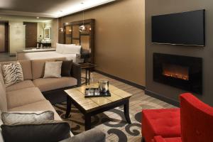 a living room with a couch and a fireplace at Metropolitan at The 9, Autograph Collection in Cleveland