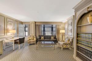 a living room with a couch and chairs and a table at The Madison Hotel in Washington, D.C.