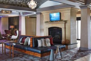 a living room with a couch and a fireplace at Rochester Airport Marriott in Rochester