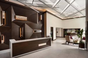 an office lobby with a large wooden wall at AC Hotel by Marriott Austin-University in Austin