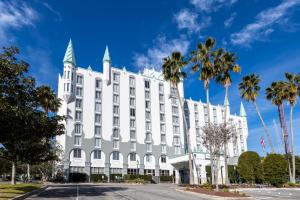 a white building with palm trees in front of it at Castle Hotel, Autograph Collection in Orlando