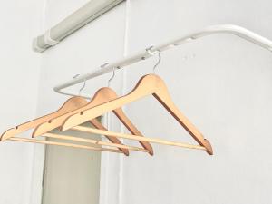 a wooden hanger hanging in a room at Seamsak hotel in Golden Triangle