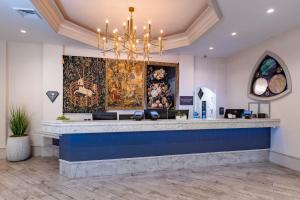 a salon with a blue counter and a chandelier at Castle Hotel, Autograph Collection by Marriott in Orlando