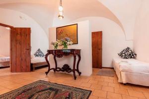a living room with a table with flowers on it at Masseria Spina Resort in Monopoli