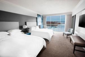 a hotel room with two beds and a large window at Niagara Falls Marriott on the Falls in Niagara Falls