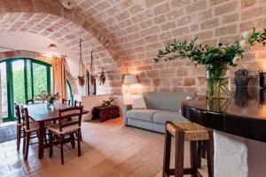 a living room with a table and a couch at Masseria Spina Resort in Monopoli
