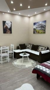 a living room with a couch and a table at Apartment Downtown in Podgorica