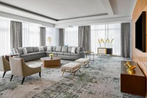 a large living room with a couch and a tv at The Ritz-Carlton, Charlotte in Charlotte