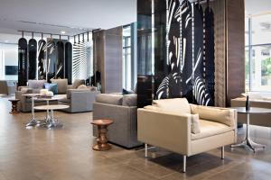 a lobby with couches and tables in a store at AC Hotel by Marriott Grand Rapids Downtown in Grand Rapids