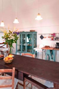 a kitchen with a table with a bowl of fruit at Masseria Spina Resort in Monopoli