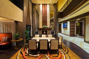 a conference room with a table and chairs and a fireplace at Denver Marriott South at Park Meadows in Lone Tree