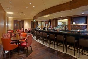 a bar in a restaurant with tables and chairs at Denver Marriott South at Park Meadows in Lone Tree