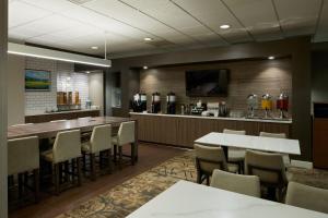 a restaurant with a bar with a table and chairs at Residence Inn Los Angeles Westlake Village in Westlake Village