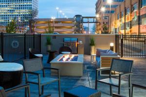 a rooftop patio with chairs and a fire pit at Residence Inn by Marriott Tulsa Downtown in Tulsa
