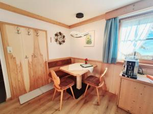 a dining room with a table and two chairs at Appartements Luttinger in Biberwier