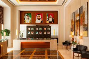 a lobby with a bar with portraits on the wall at Four Points by Sheraton Sheikh Zayed Road in Dubai