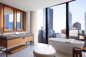 a bathroom with a tub and a large window at The Ritz-Carlton, Perth in Perth