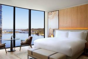 a bedroom with a large bed and a large window at The Ritz-Carlton, Perth in Perth