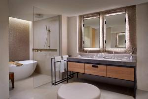 a bathroom with a tub and a sink and a toilet at The Ritz-Carlton, Perth in Perth