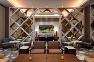 a restaurant with tables and chairs and a wall of wine racks at The Westin Anaheim Resort in Anaheim