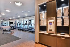 a gym with treadmills and a row of tread meters at Courtyard by Marriott Bentonville Rogers Promenade in Rogers