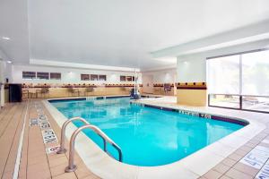 a large swimming pool with blue water at SpringHill Suites By Marriott Erie in Erie
