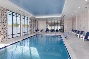 a large swimming pool with blue water in a building at Courtyard by Marriott Richmond Scott's Addition in Richmond