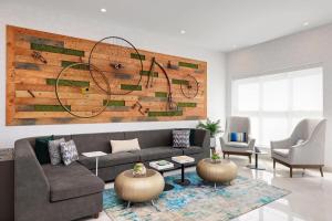 a living room with a couch and two chairs at Element New York Wood Ridge in Wood-Ridge