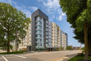 a tall building on a city street with trees at Residence Inn by Marriott Cleveland University Circle/Medical Center in Cleveland