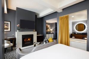 a bedroom with a bed and a fireplace at Hotel Metro, Autograph Collection in Milwaukee