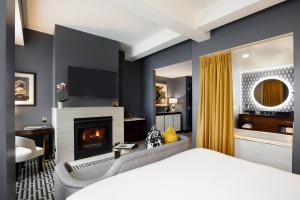 a bedroom with a bed and a fireplace at Hotel Metro, Autograph Collection in Milwaukee +43 photos