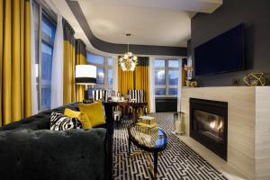 a living room with a couch and a fireplace at Hotel Metro, Autograph Collection in Milwaukee