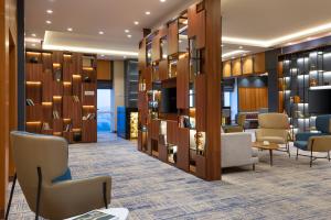a lobby with chairs and a waiting room at Courtyard by Marriott Tashkent in Tashkent