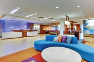 a living room with a blue couch in a lobby at Fairfield Inn & Suites by Marriott Dunn I-95 in Dunn
