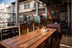a wooden table and chairs on a patio at TT Hostel in Vientiane