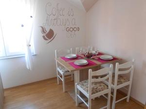 a dining room table with chairs and a sign that says cut is always a good at Apartment Luna 4 person in Bribir +30 photos