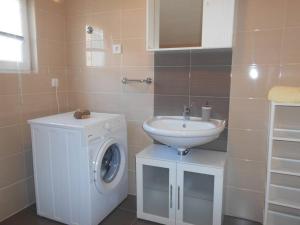 a bathroom with a washing machine and a sink at Apartment Luna 4 person in Bribir