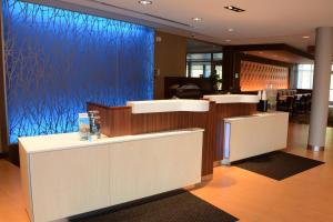 a lobby with a blue wall with a barber shop at Fairfield Inn & Suites By Marriott Somerset in Somerset