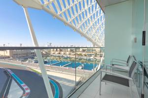 a balcony with chairs and a view of a bridge at W Abu Dhabi - Yas Island in Abu Dhabi