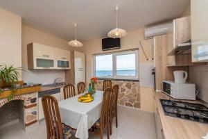a kitchen with a table with bananas on it at Apartments Delfin with seaview 100 meters from the sea - by TA Leut Agency in Privlaka