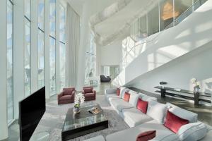 a living room with a white couch and red pillows at W Abu Dhabi - Yas Island in Abu Dhabi