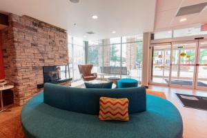a living room with a blue couch and a fireplace at Fairfield Inn & Suites by Marriott Atlanta Woodstock in Woodstock